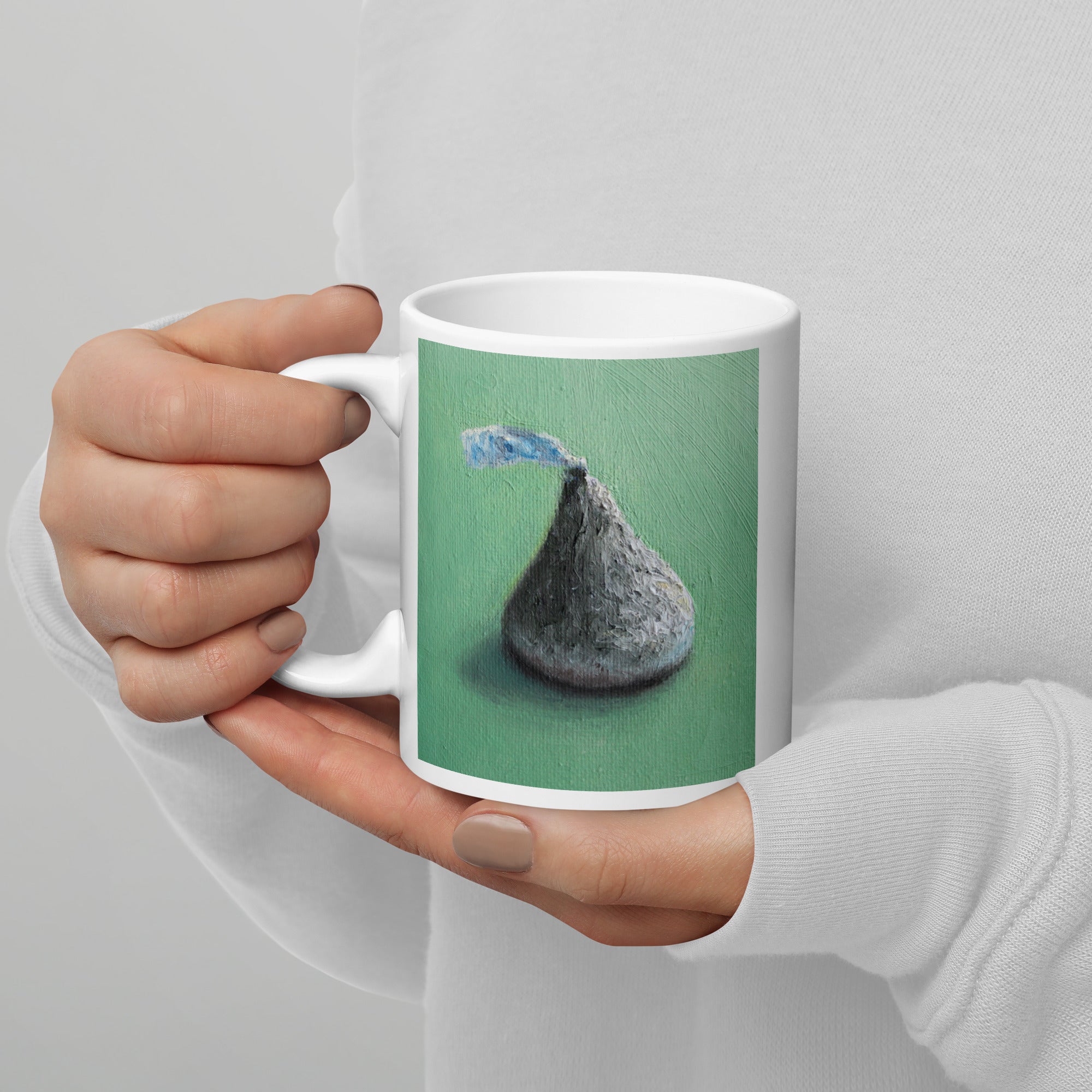 Coffee mug with mint background with a Hershey’s Kiss